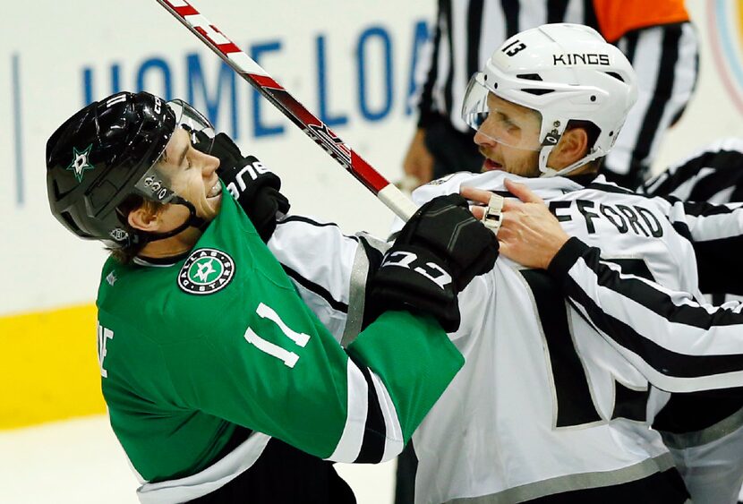 Los Angeles Kings left wing Kyle Clifford (13) grabs Dallas Stars left wing Curtis McKenzie...