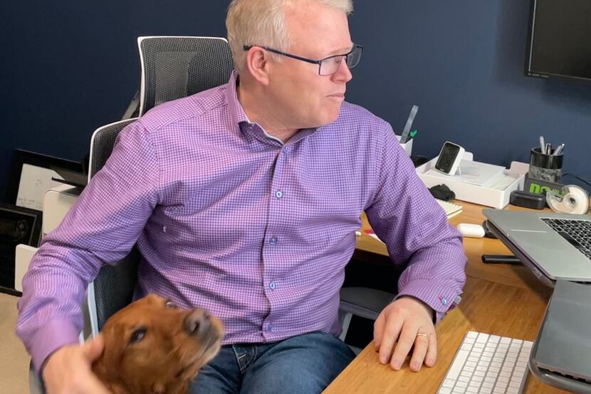Doug Claffey, founder of Energage, with his "assistant," Mazie the golden retriever, at his...
