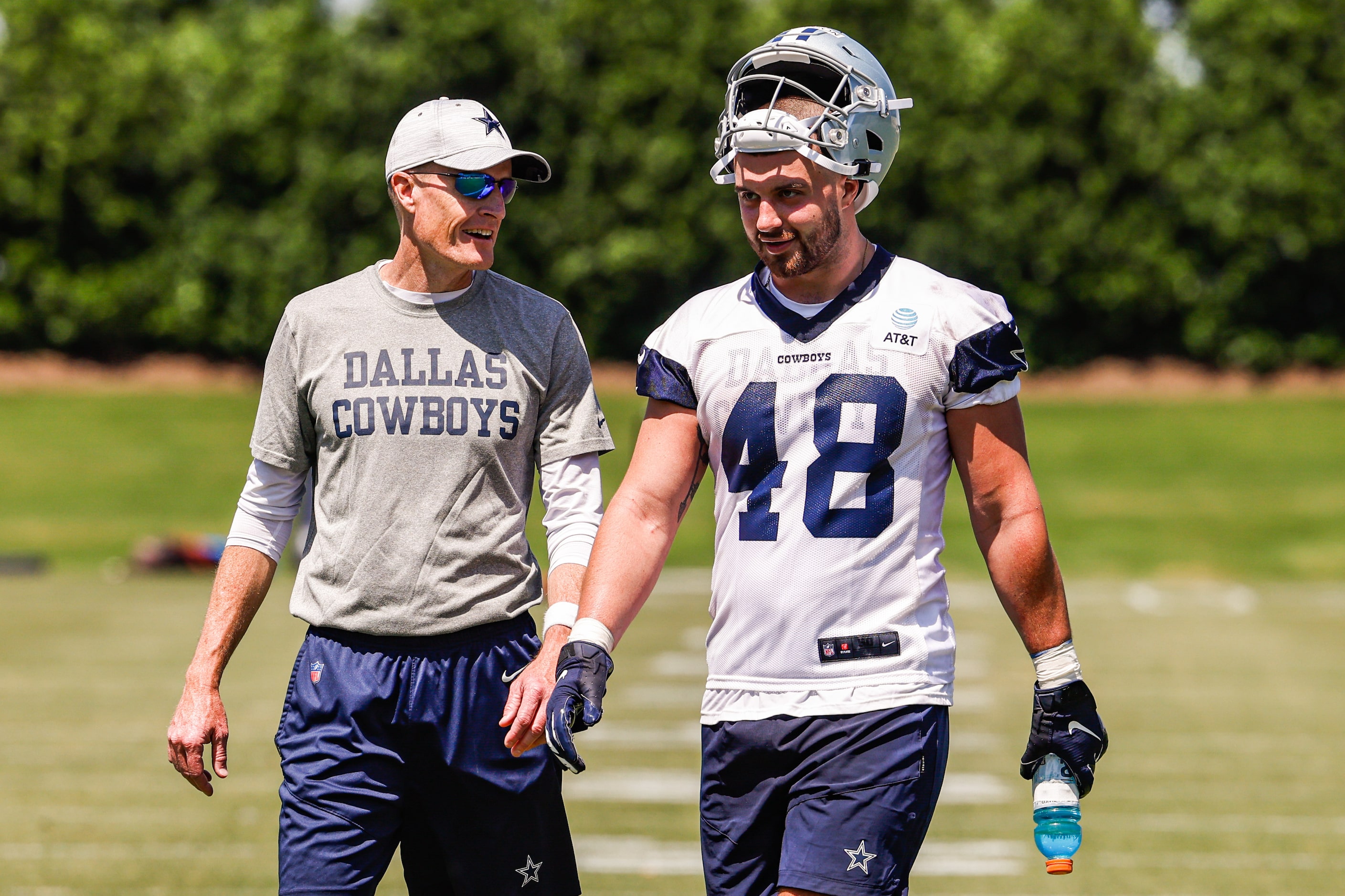 Dallas Cowboys offensive line coach Joe Philbin with tight end (48) Jake Ferguson as they...