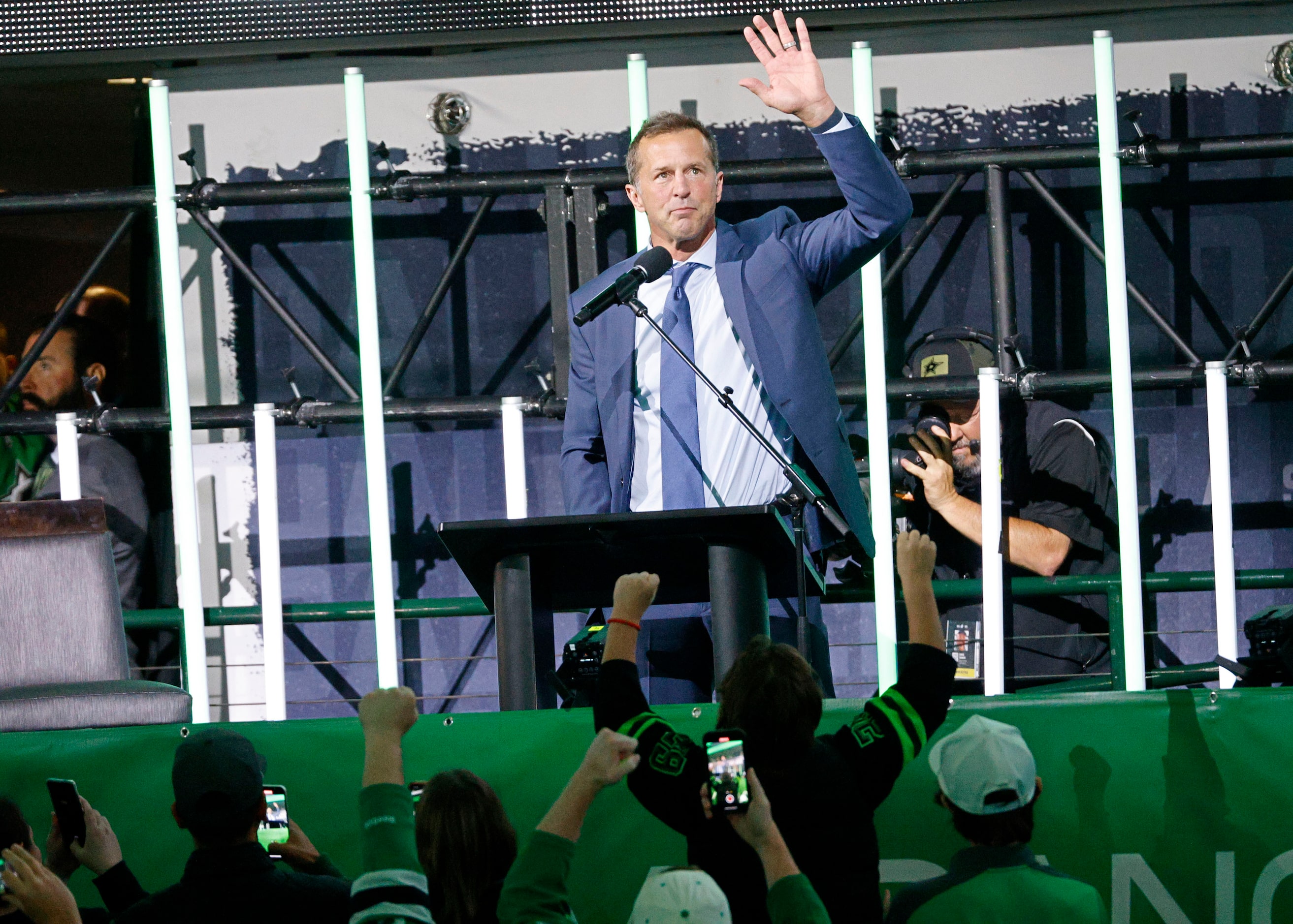 Dallas Stars legend Mike Modano waves during the unveiling ceremony of his statue at the...