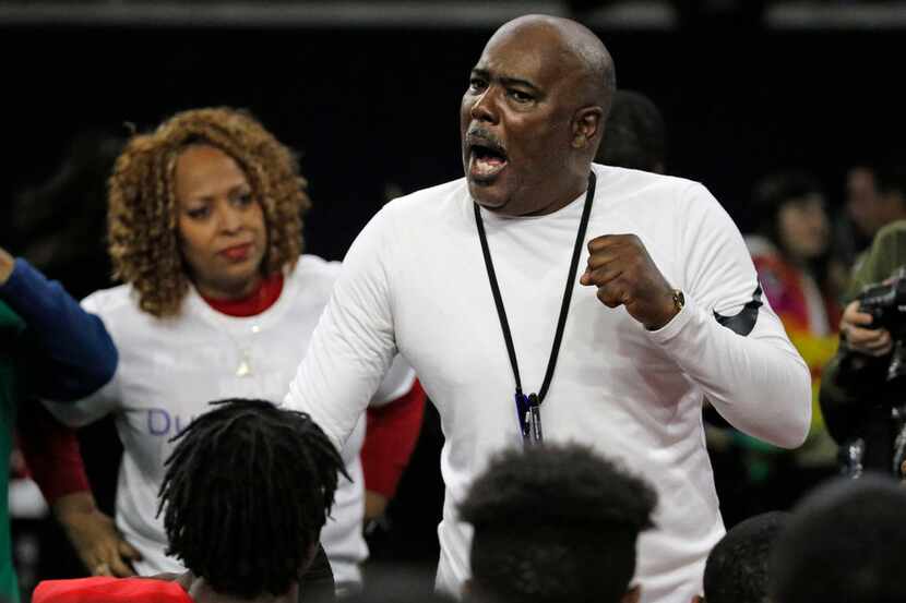 Duncanville head coach Reginald Samples talks with his players after their 51-7 win during...