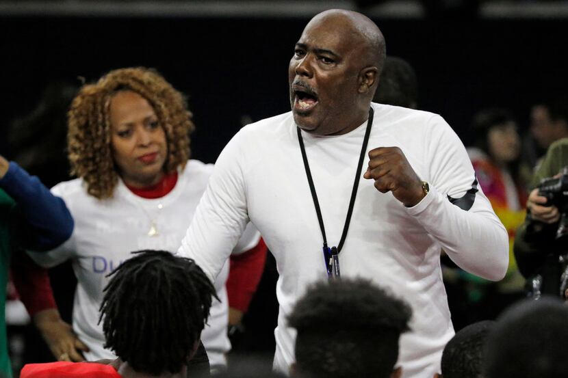 Duncanville head coach Reginald Samples talks with his players after their 51-7 win during...