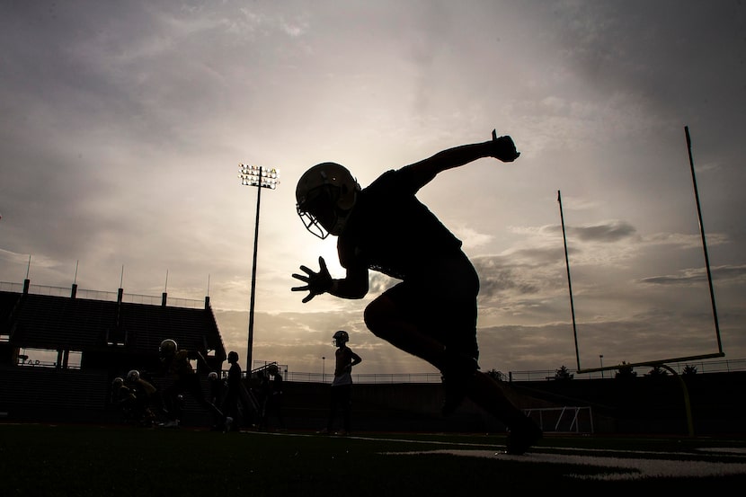 South Oak Cliff players run a drill during their season-opening football practice at John...