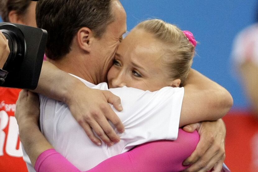 Nastia Liukin gets a hug from her father Valeri Liukin after winning gold in the Women's...