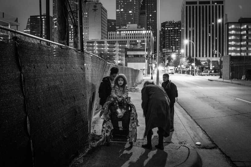 A black-and-white photo by photographer Richard Sharum shows a homeless mother and her...