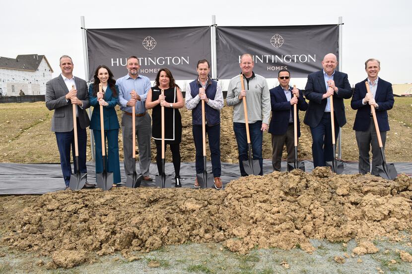 Officials and executives celebrate the groundbreaking of a new model home from Huntington...