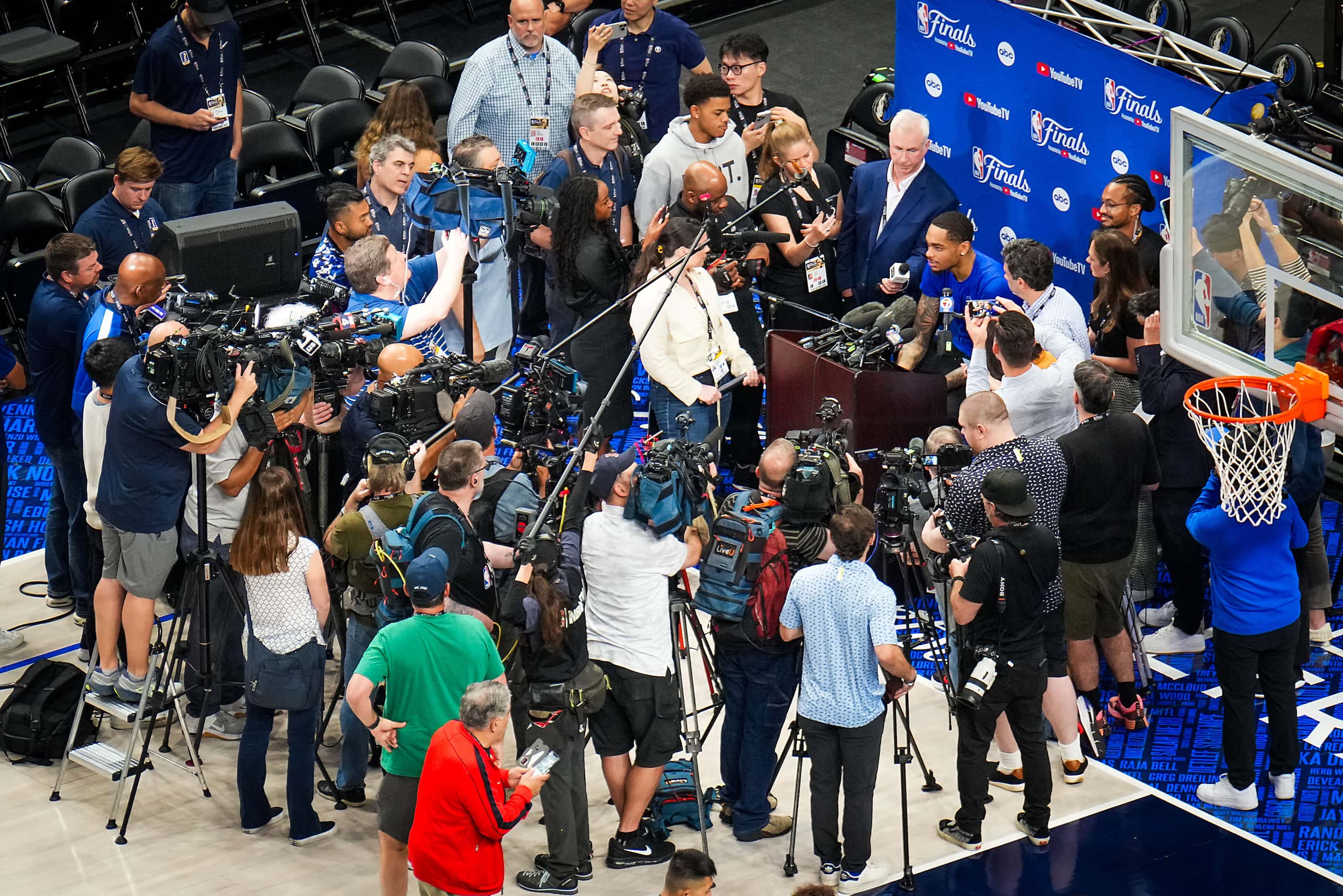 Dallas Mavericks forward P.J. Washington is surrounded by media after a team practice in...