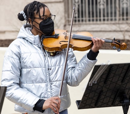 Aissatou Rasa,15, plays music after the ceremony remembering the life of 12-year-old Santos...