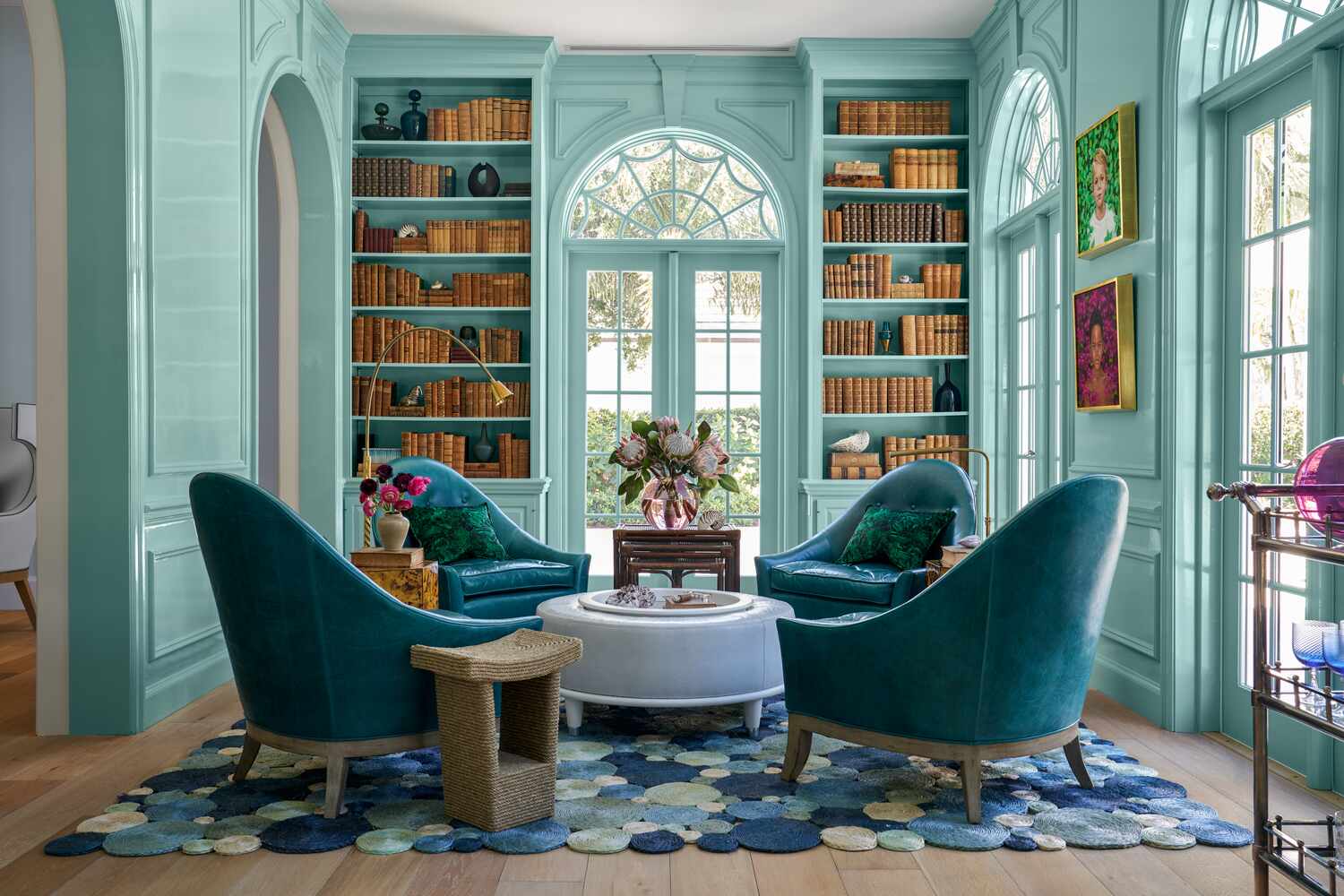 Bright blue library with blue chairs and a blue bubble rug, four chairs clustered around table