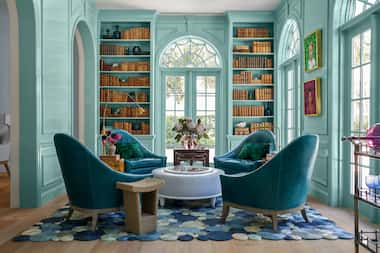 Bright blue library with blue chairs and a blue bubble rug, four chairs clustered around table
