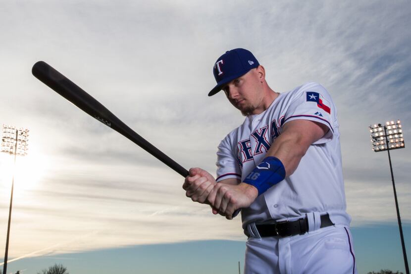Texas Rangers left fielder Ryan Rua (16) poses for a portrait on photo day during spring...