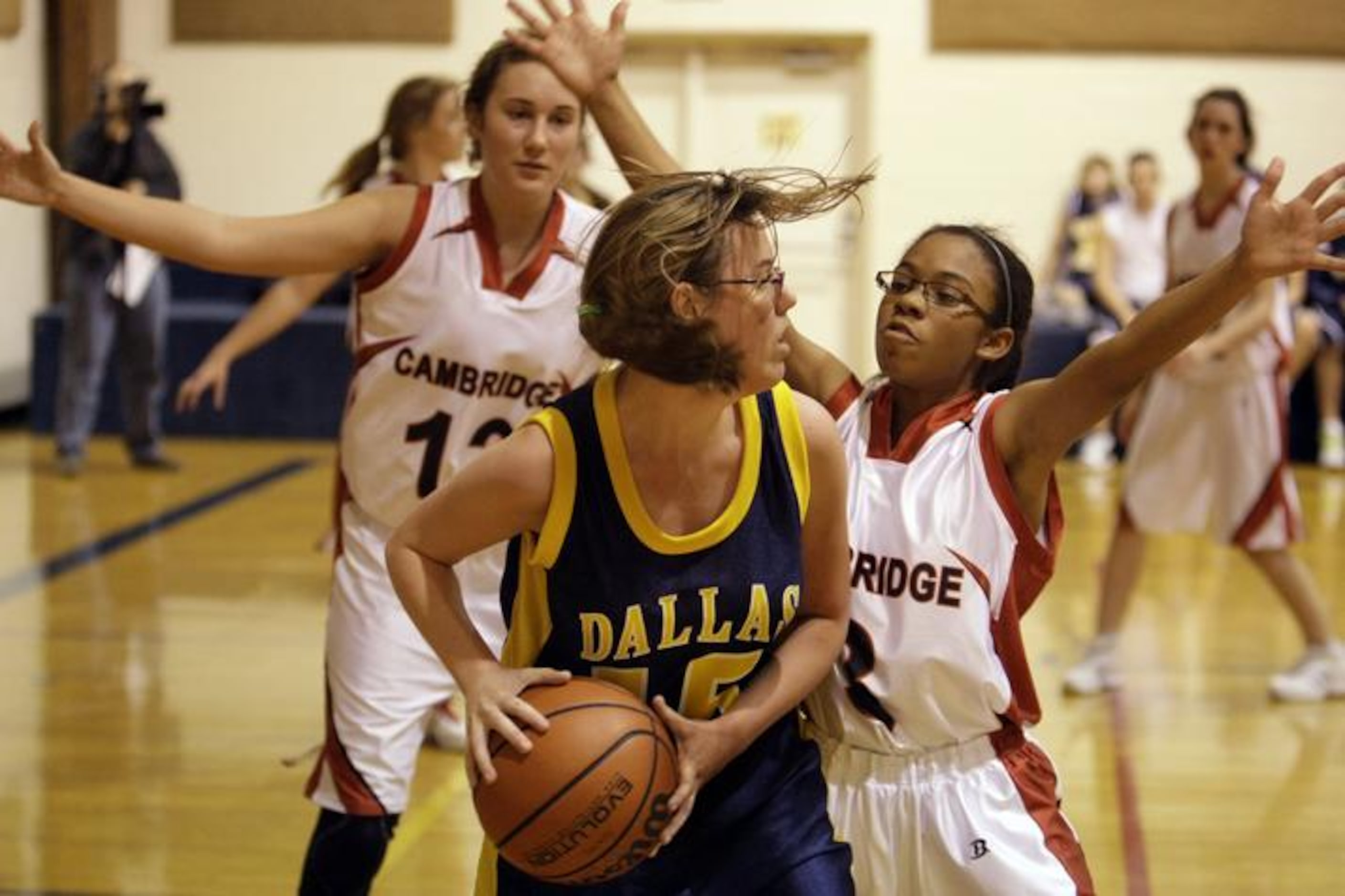 Dallas Academy freshman forward/center Samantha Peloza (15) looks to pass around Cambridge's...