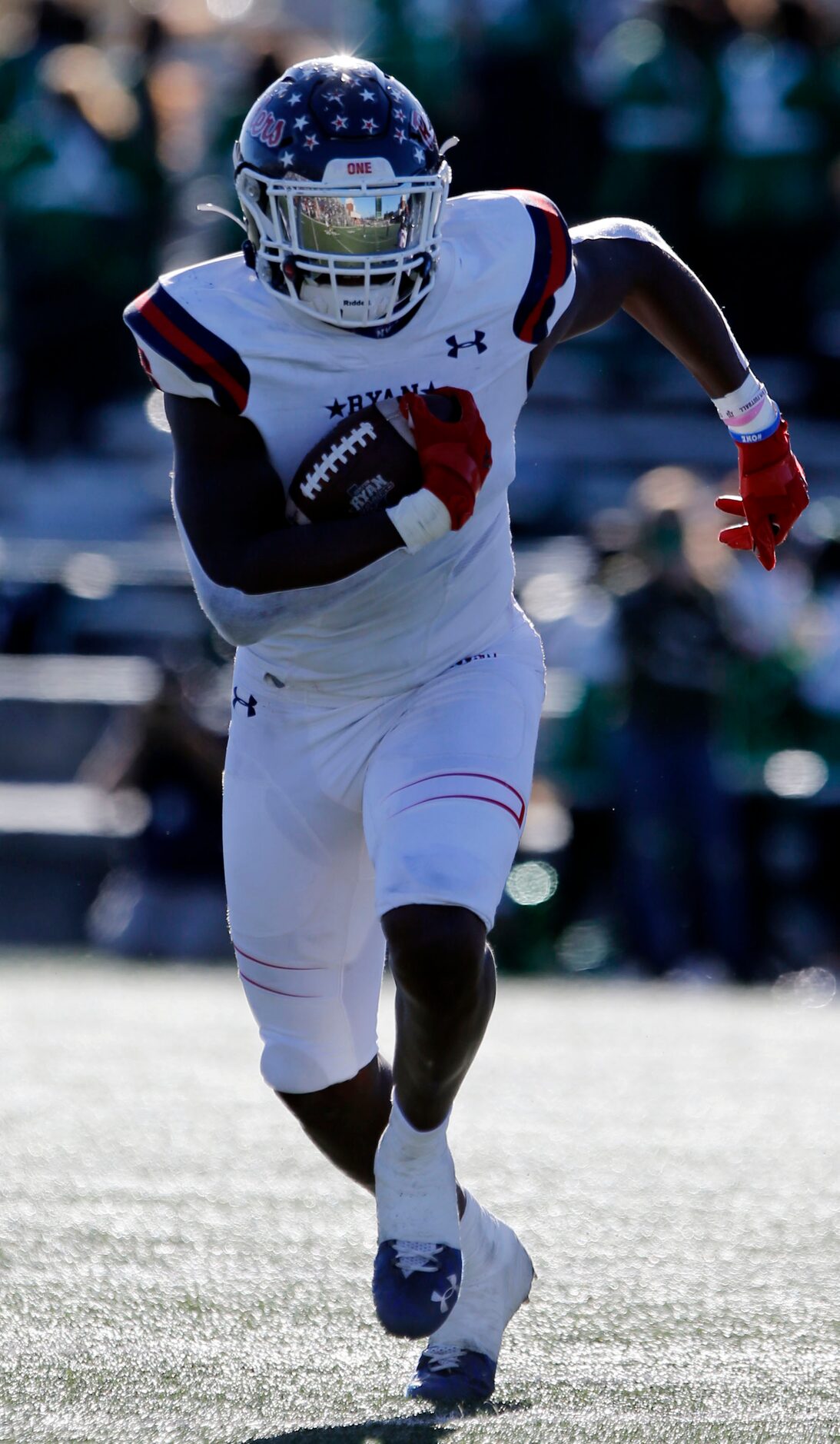 The field is reflected in the facemask visor of Denton Ryan RB Anthony Hill Jr during the...