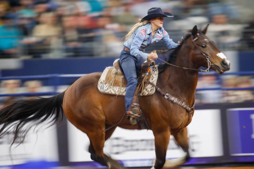 Stevi Hillman, of Weatherford, competes in the barrel racing competition of RFD-TV's The...