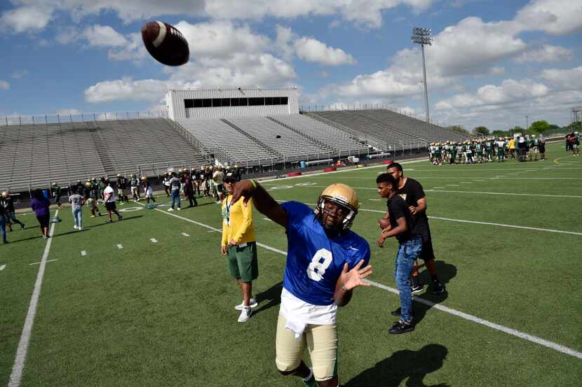 Senior quarterback Courtney Douglas tosses a pass to the end-zone during DeSoto High...