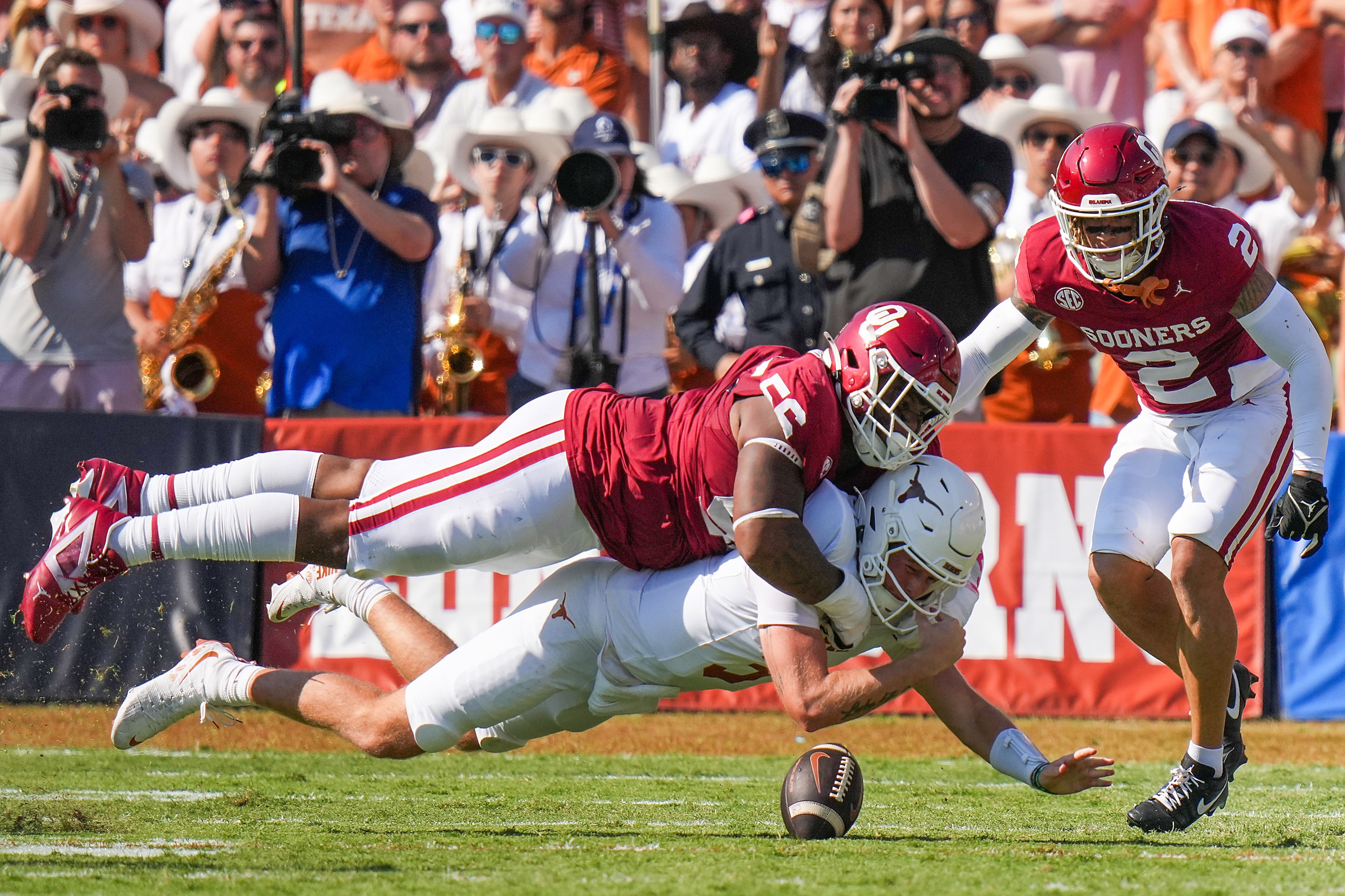 Texas quarterback Quinn Ewers (3) is brought down by Oklahoma defensive lineman Gracen...