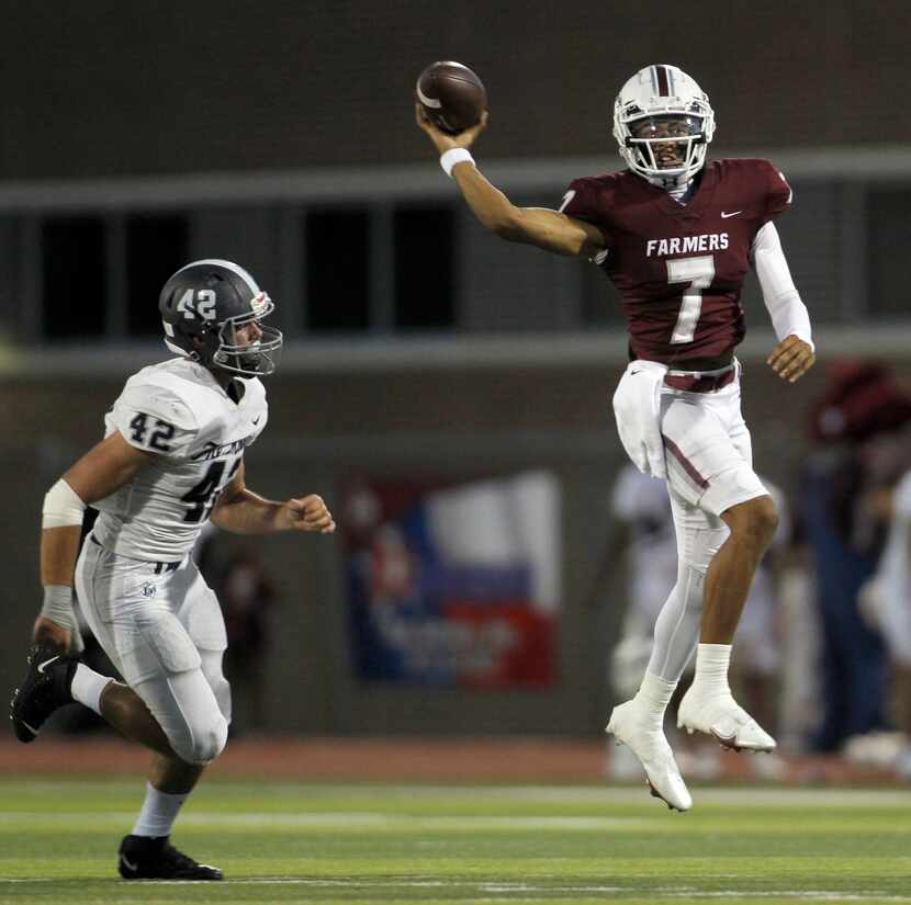 Lewisville quarterback Ethan Terrell (7) leaps and launches a touchdown pass to receiver...