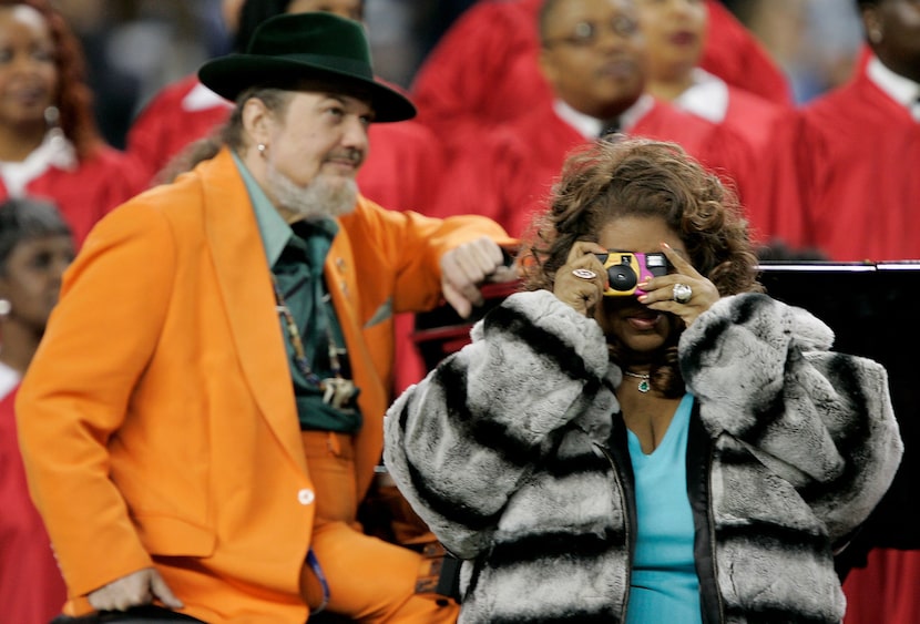 Singer Aretha Franklin takes a picture during the national anthem prior to the start of...