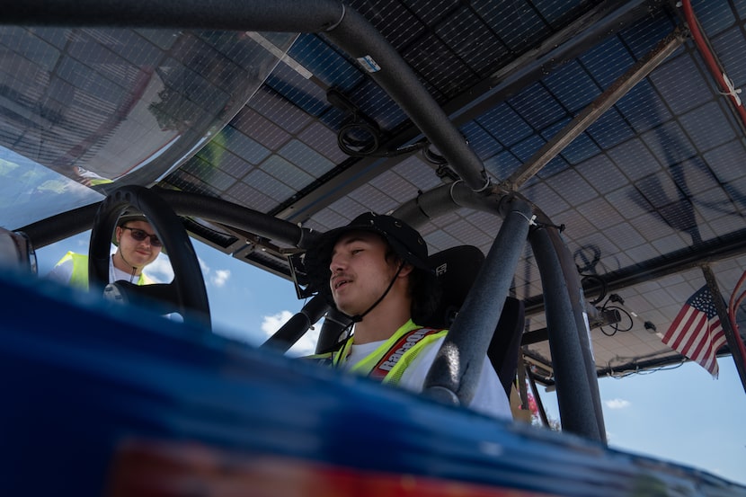 Harmony Public School students prepare to test their solar-powered vehicle on the track...