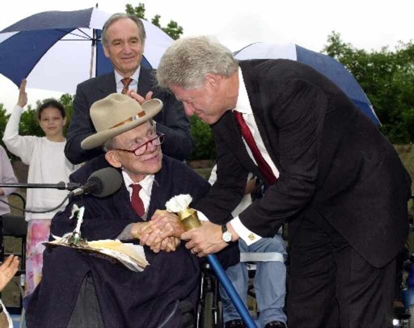 President Clinton accepts the Spirit of ADA torch from human rights advocate Justin Dart...