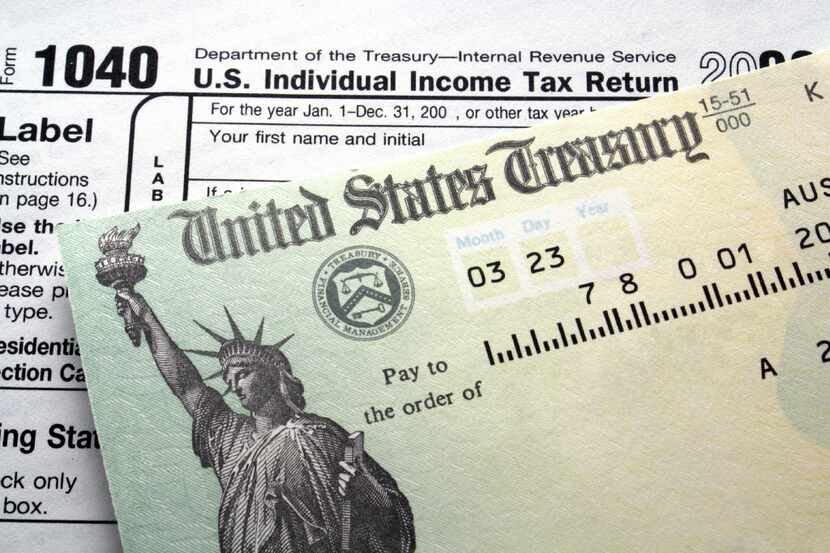 Tax return check on 1040 form background __ Caption: income tax refund check for econ and...