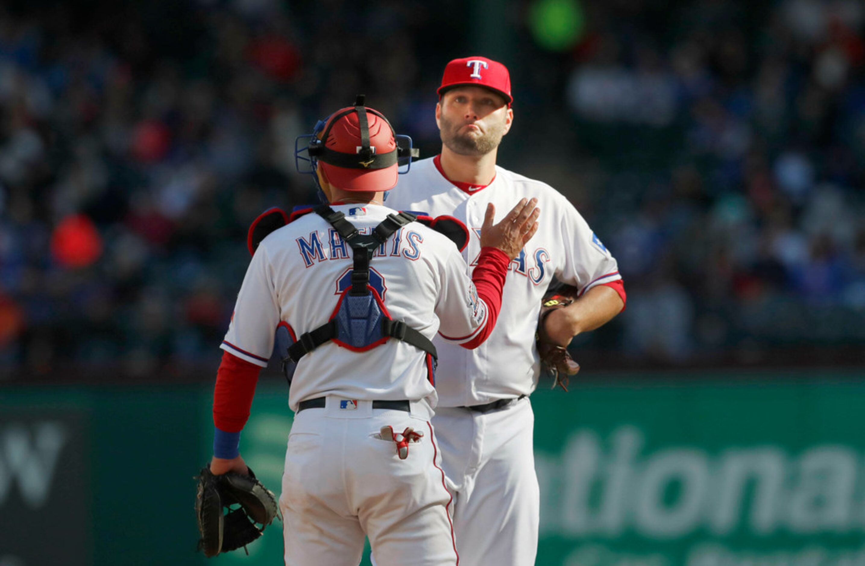 Texas Rangers starting pitcher Lance Lynn (35) is comforted by Jeff Mathis just before Lynn...