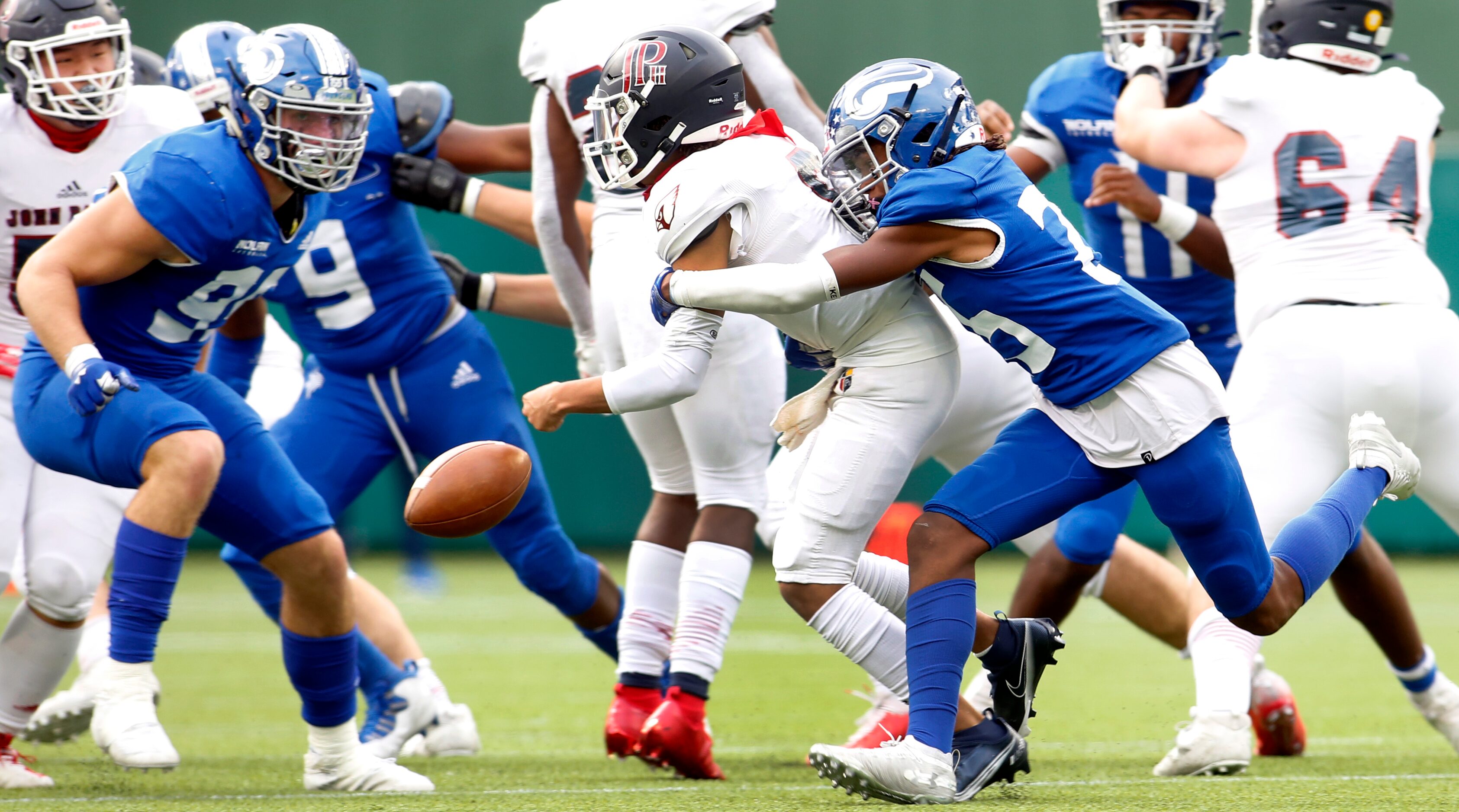 Fort Worth Nolan defensive back Gerald Lacy (25), right, forces a fumble by Plano John Paul...