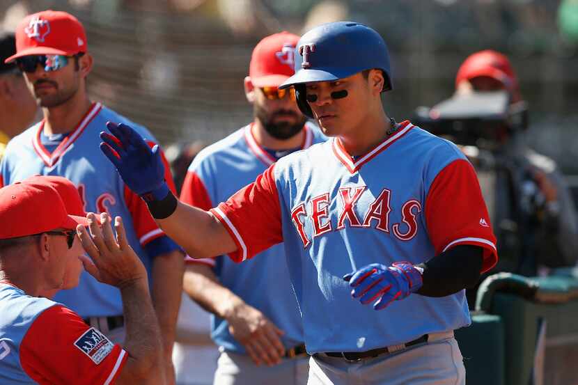 OAKLAND, CA - AUGUST 26: Shin-Soo Choo #17 of the Texas Rangers celebrates with teammates in...