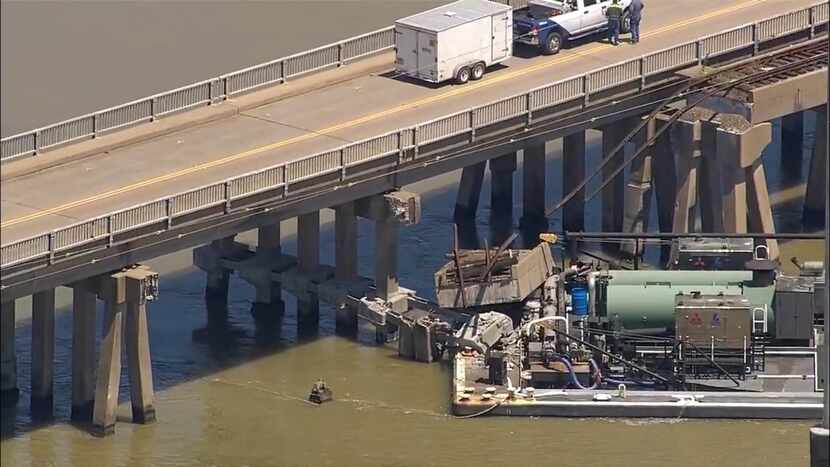 Oil spills into the surrounding waters after a barge hit a bridge in Galveston, Texas, on...