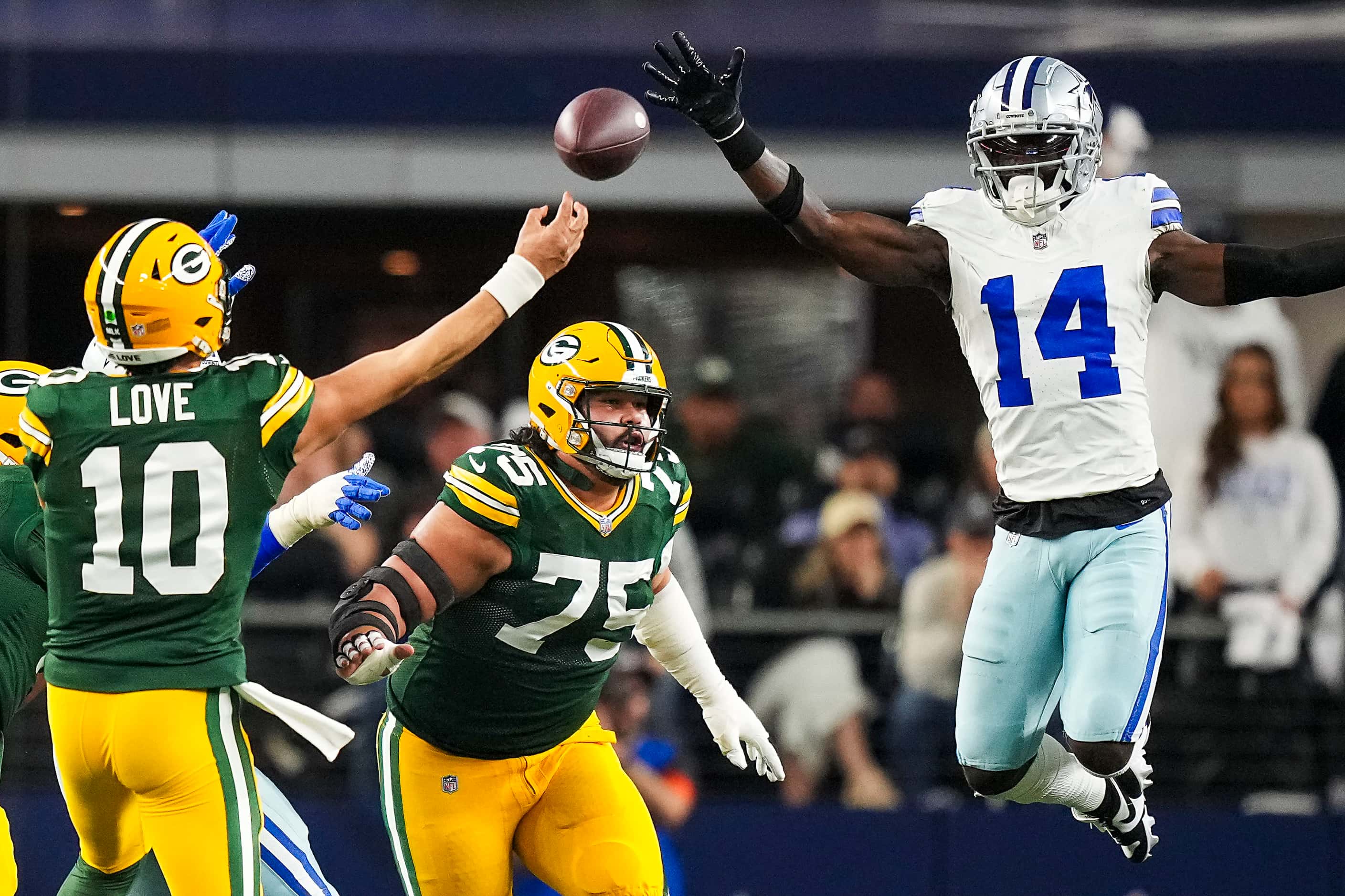 Green Bay Packers quarterback Jordan Love (10) throws a touchdown pass to wide receiver...