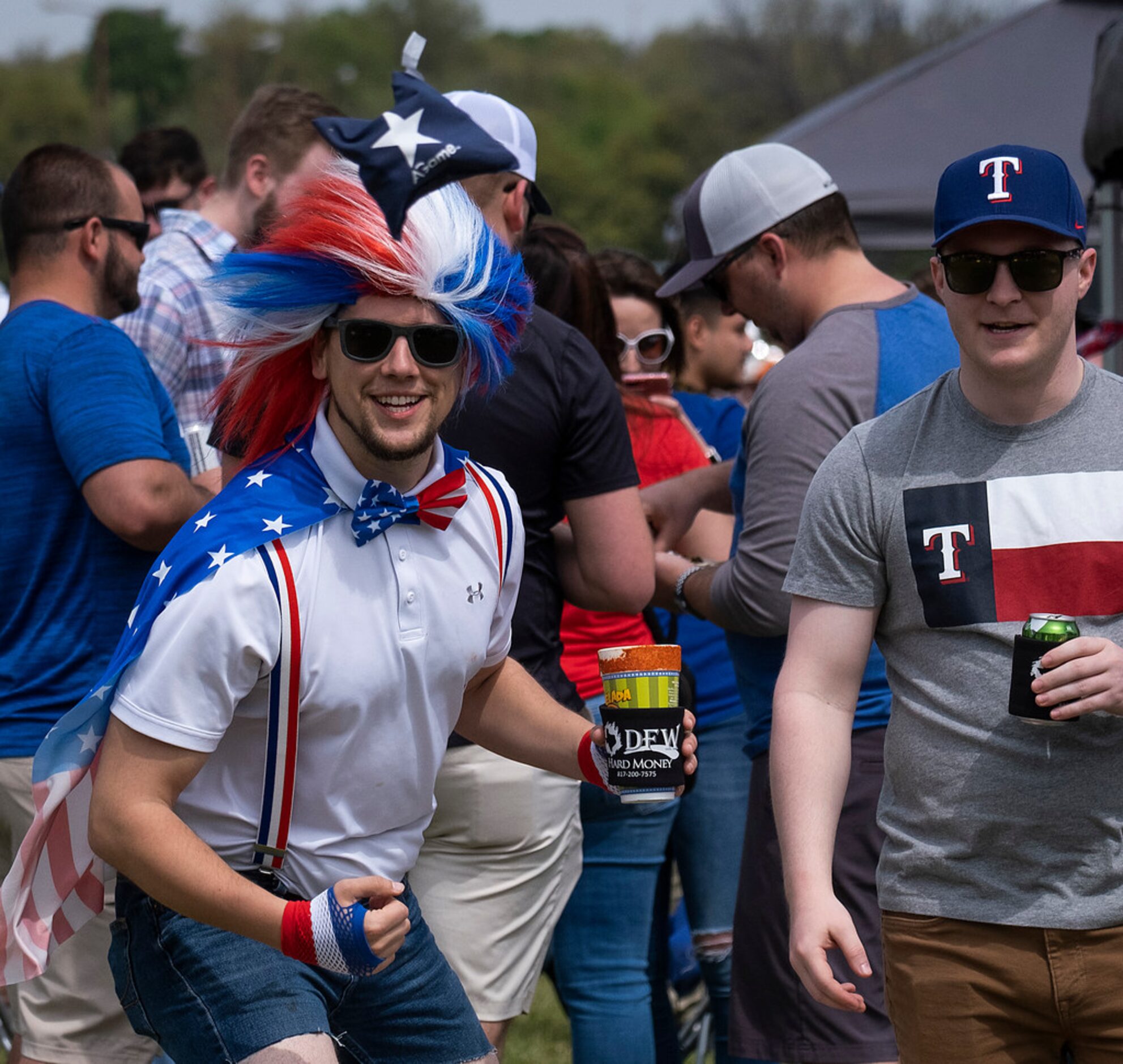 Fans Clayton Ferrell (left) and Ryan Handy play cornhole as they tailgate before the Texas...