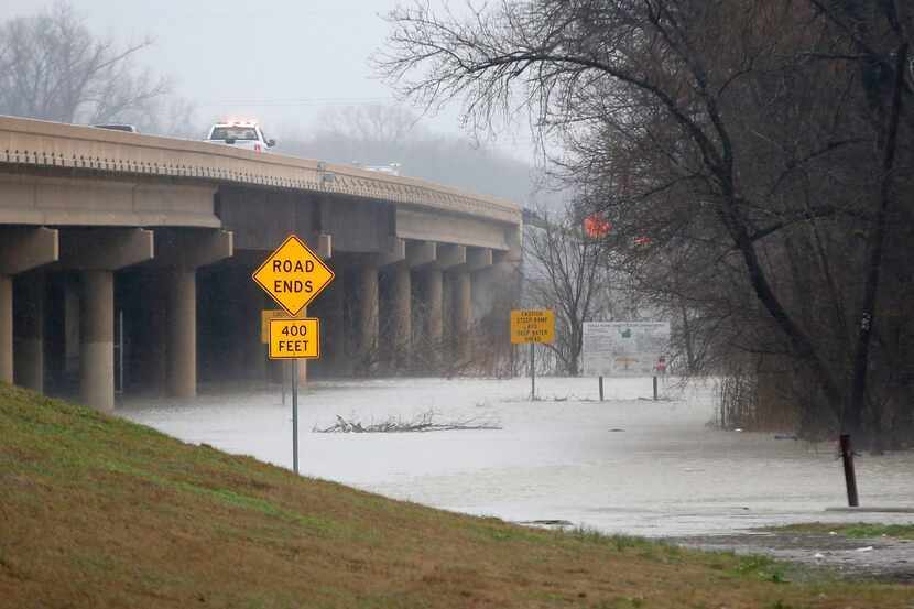 Dallas Fire-Rescue teams respond to a report that a car was swept away from under the Loop...