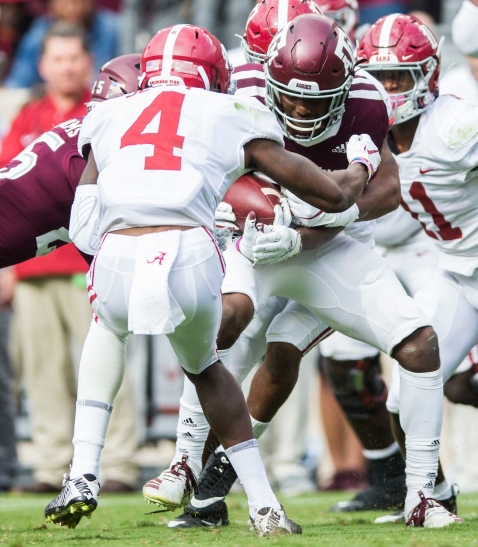 Texas A&M Aggies defensive back Demani Richardson (26) is tackled by Alabama Crimson Tide...