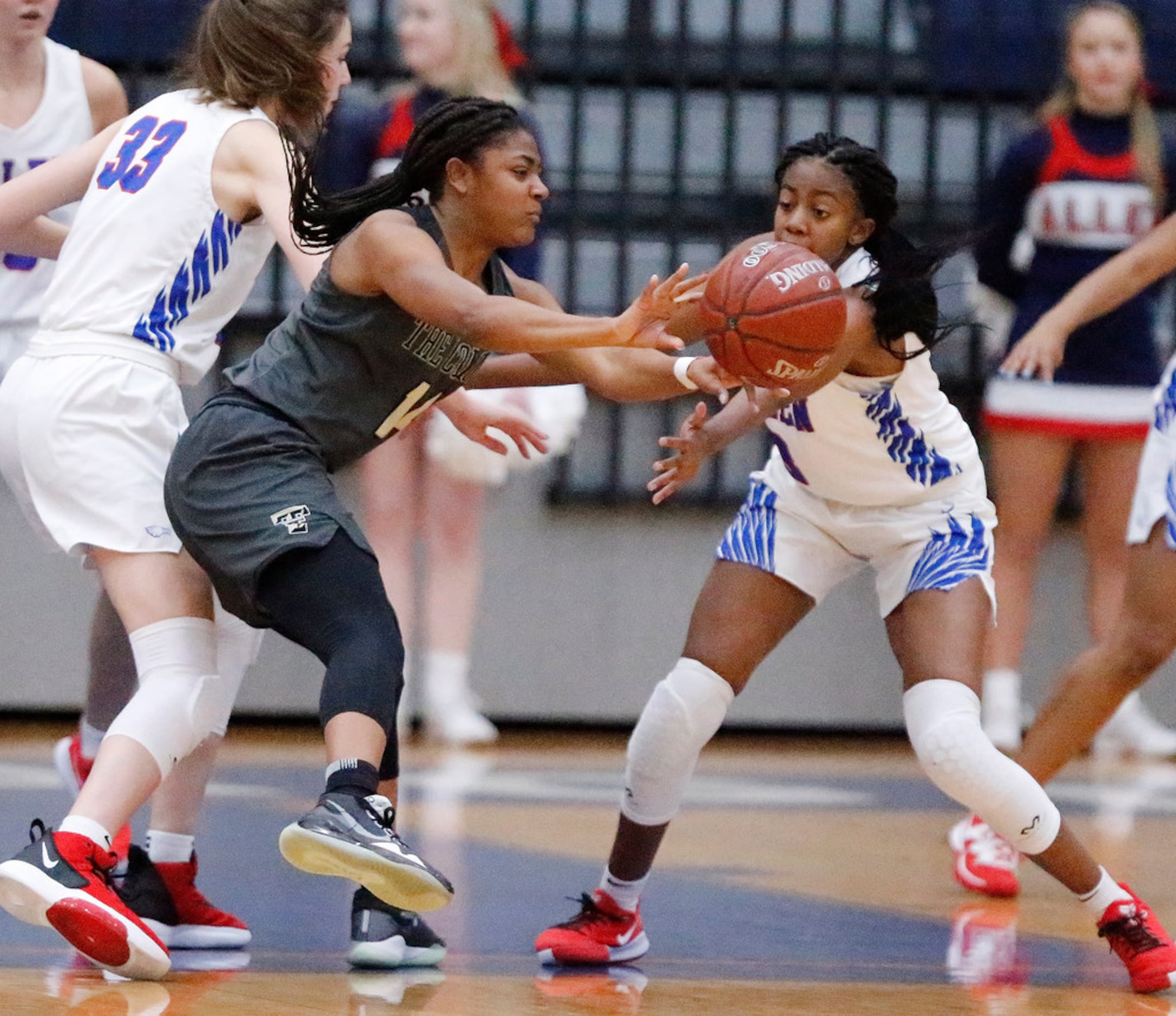 The Colony High Schoolâs Tamia Jones (14) passes the basketball during the first half as...