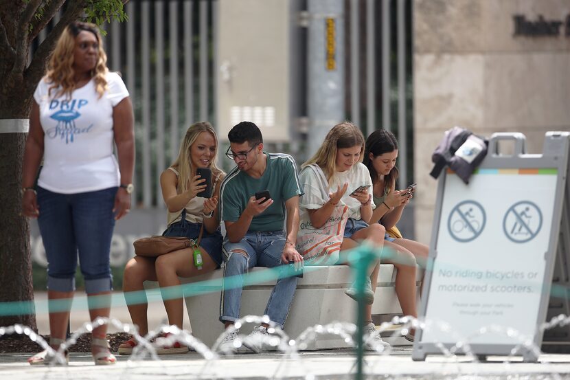 People without masks spend time at Dallas' Klyde Warren Park on June 27.