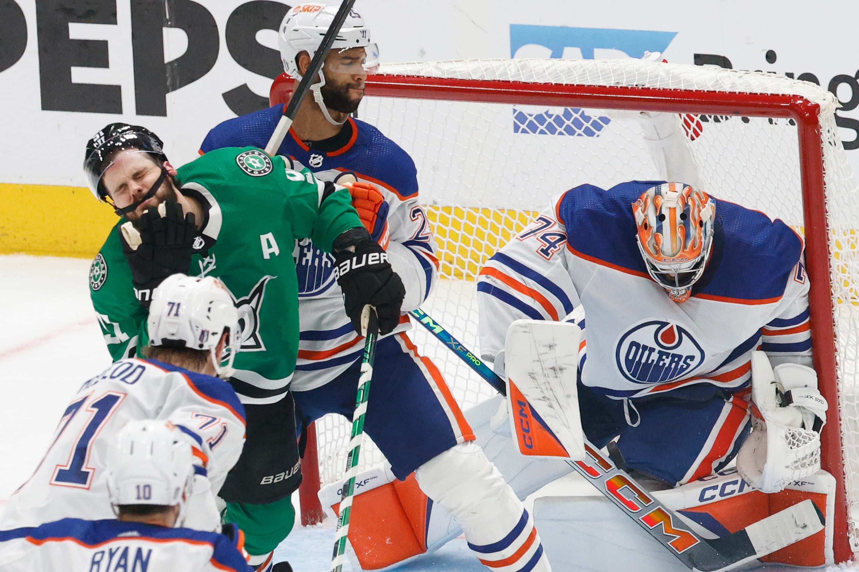 Dallas Stars center Tyler Seguin (91) is hit in the face during competing against Edmonton...