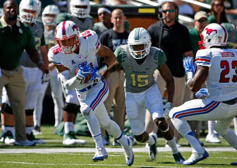 Southern Methodist defensive back Jordan Wyatt (left) intercepts a pass intended for Baylor...