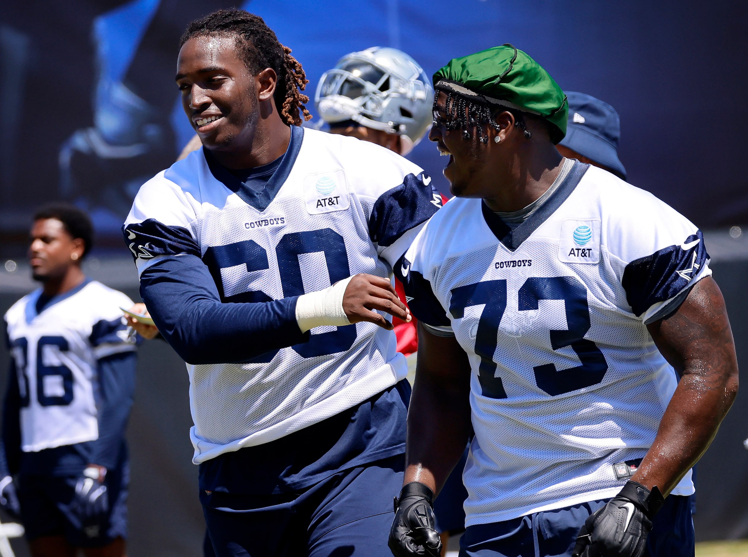 Dallas Cowboys tackle Tyler Guyton (60) and offensive tackle Tyler Smith (73) laugh after...