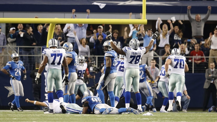 Tony Romo (9) celebrates from the ground after throwing the game winning touchdown of a...