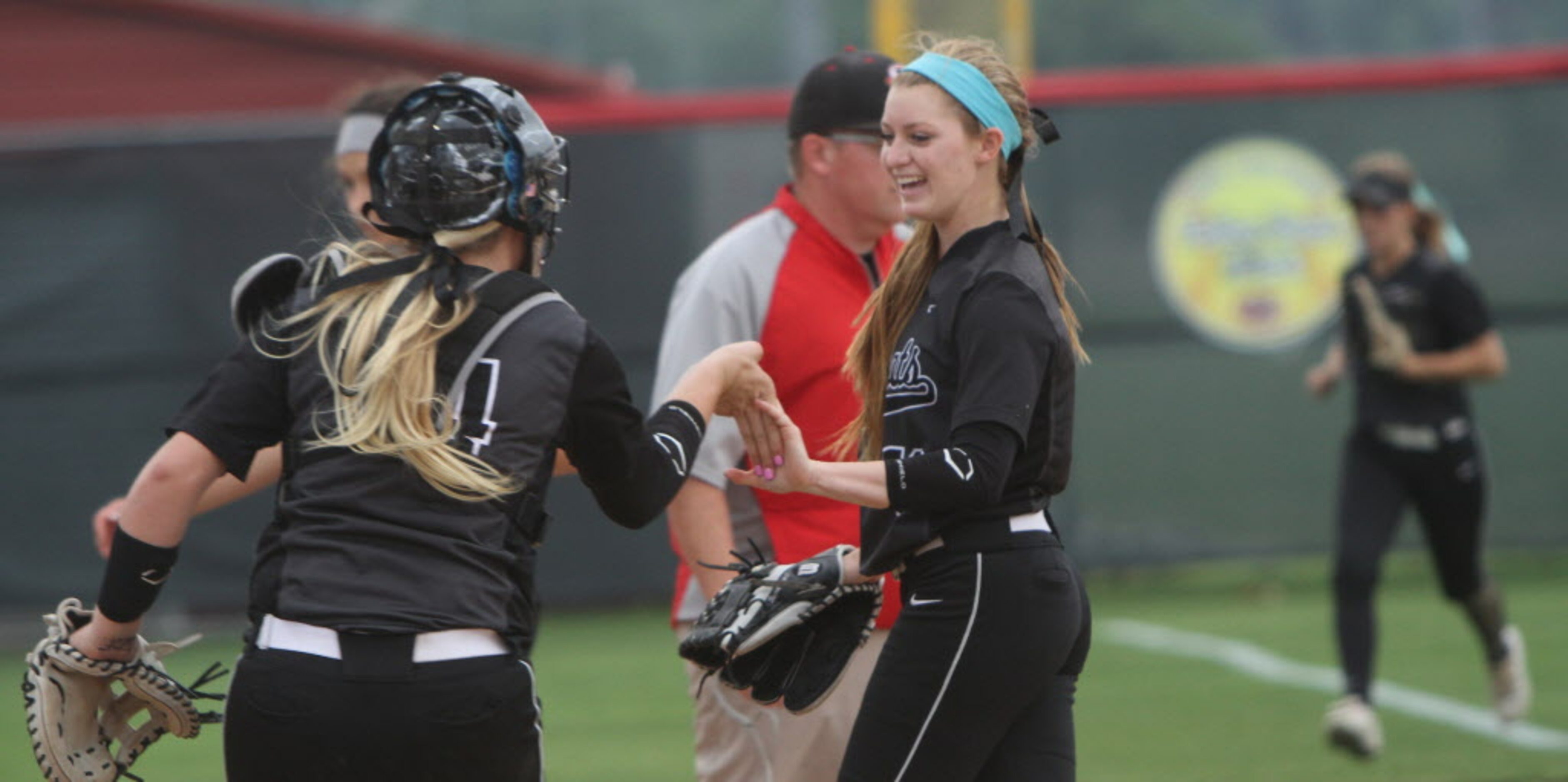 Denton Guyer pitcher Shayne Starkey (13), center, receives congratulations from catcher...