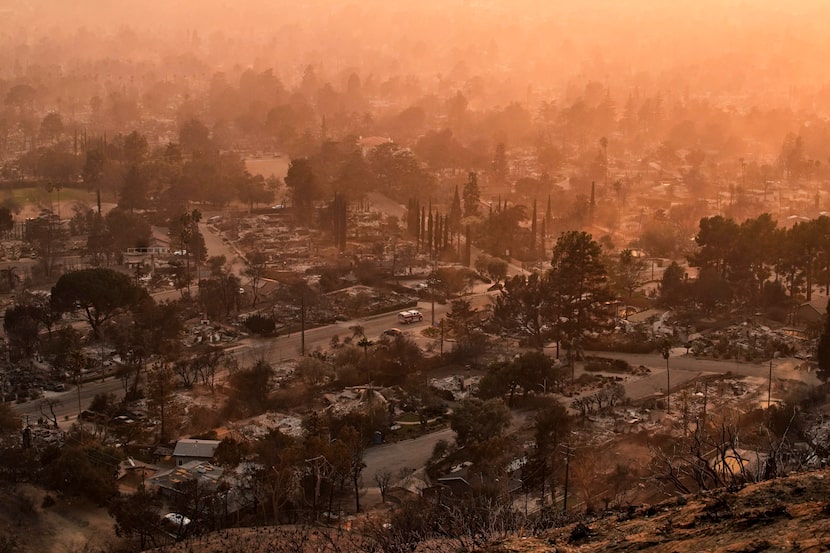 Smoke lingers over a neighborhood devastated by the Eaton Fire, Thursday, Jan. 9, 2025, in...