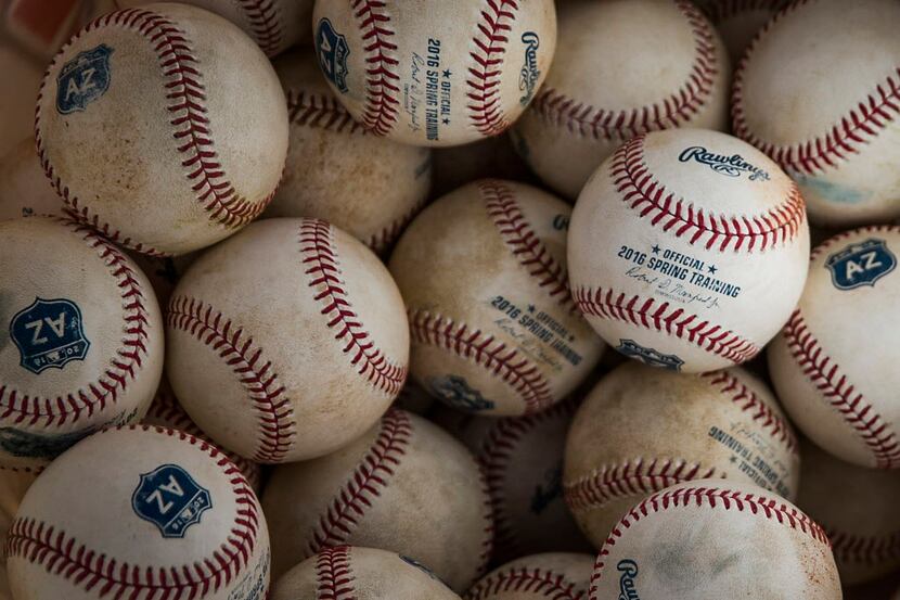 A bucket of Cactus League balls seen  during a Texas Rangers spring training intrasquad game...