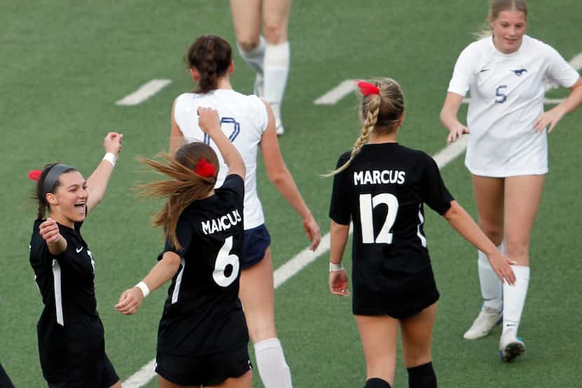 Flower Mound Marcus players Emma Fioretti (8), left, celebrates with Ava Young (6) following...