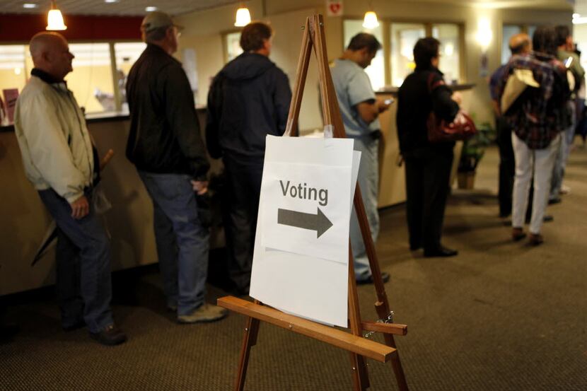Collin County voters wait to vote in a line which stretched through the lobby and three...