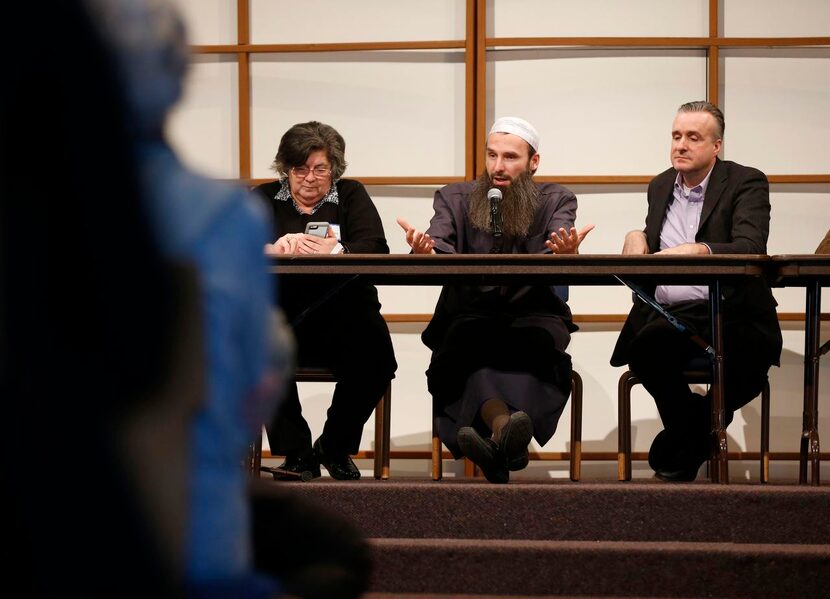 
Shpendim Nadzaku (center) speaks to the crowd as Dr. Hind Jarrah (left) and Wes Magruder...