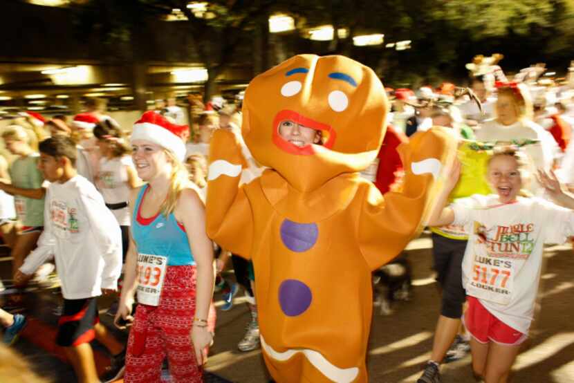 Festive runners take the streets for the Jingle Bell Run outside the Hilton Anatole.