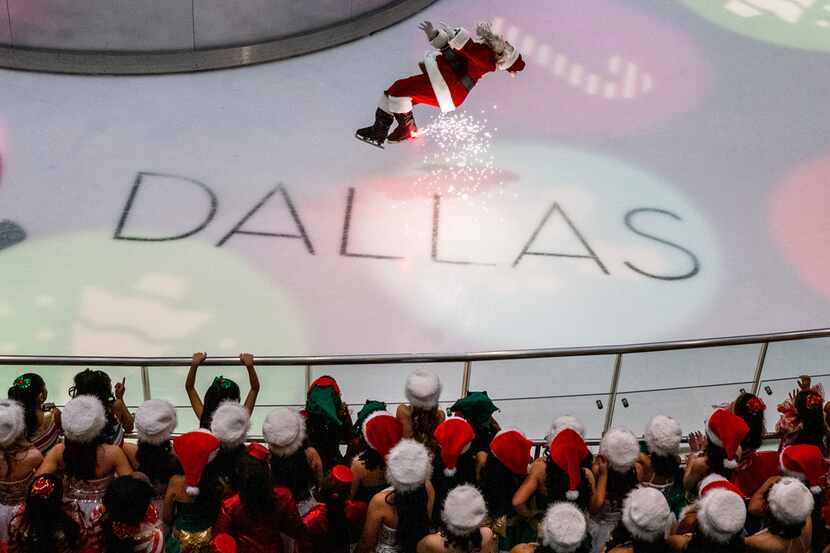 Santa performs a backflip during the Christmas tree lighting celebration at Galleria Dallas.