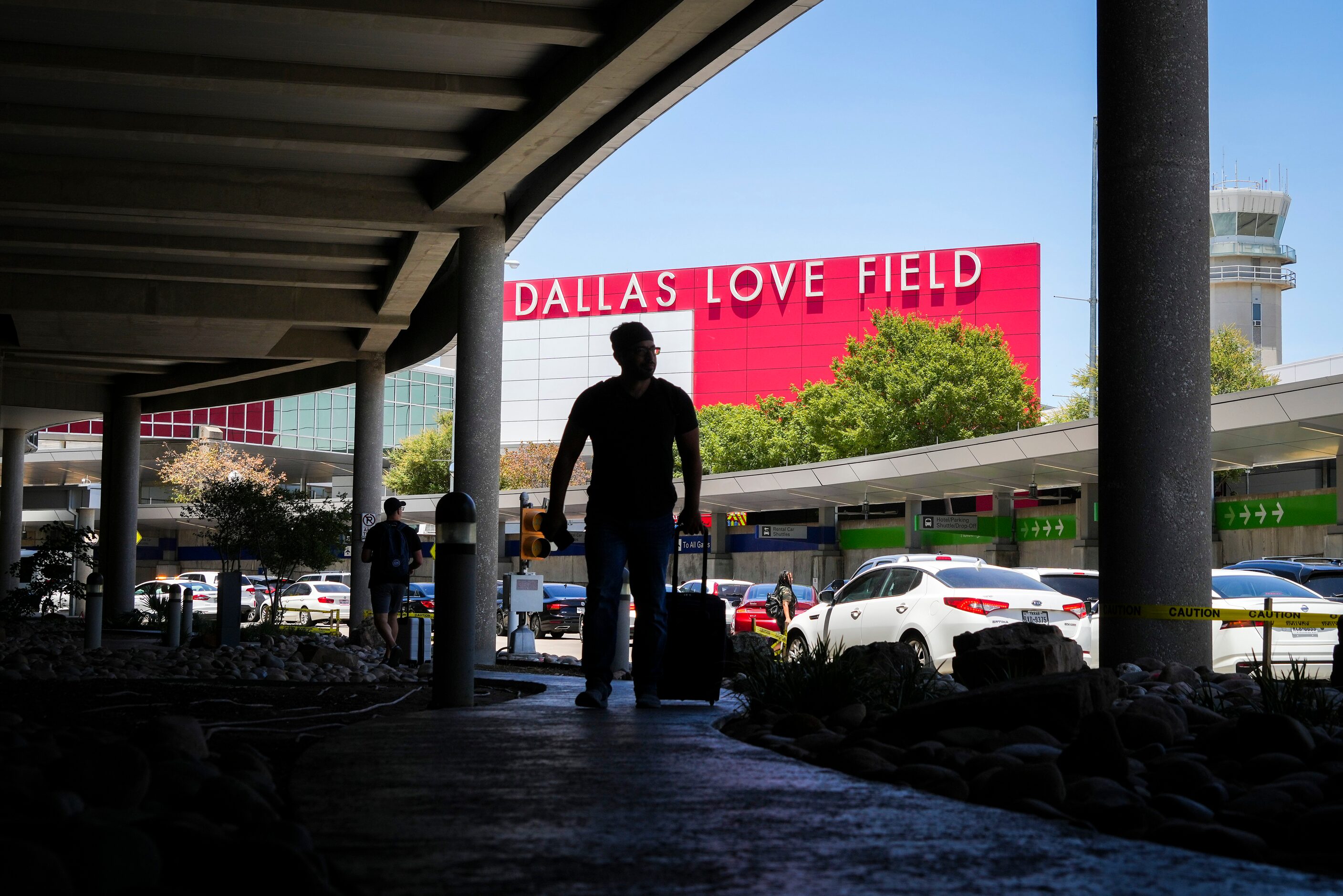 Passengers exit Dallas Love Field Airport on Monday, July 25, 2022.  A ground stop was...