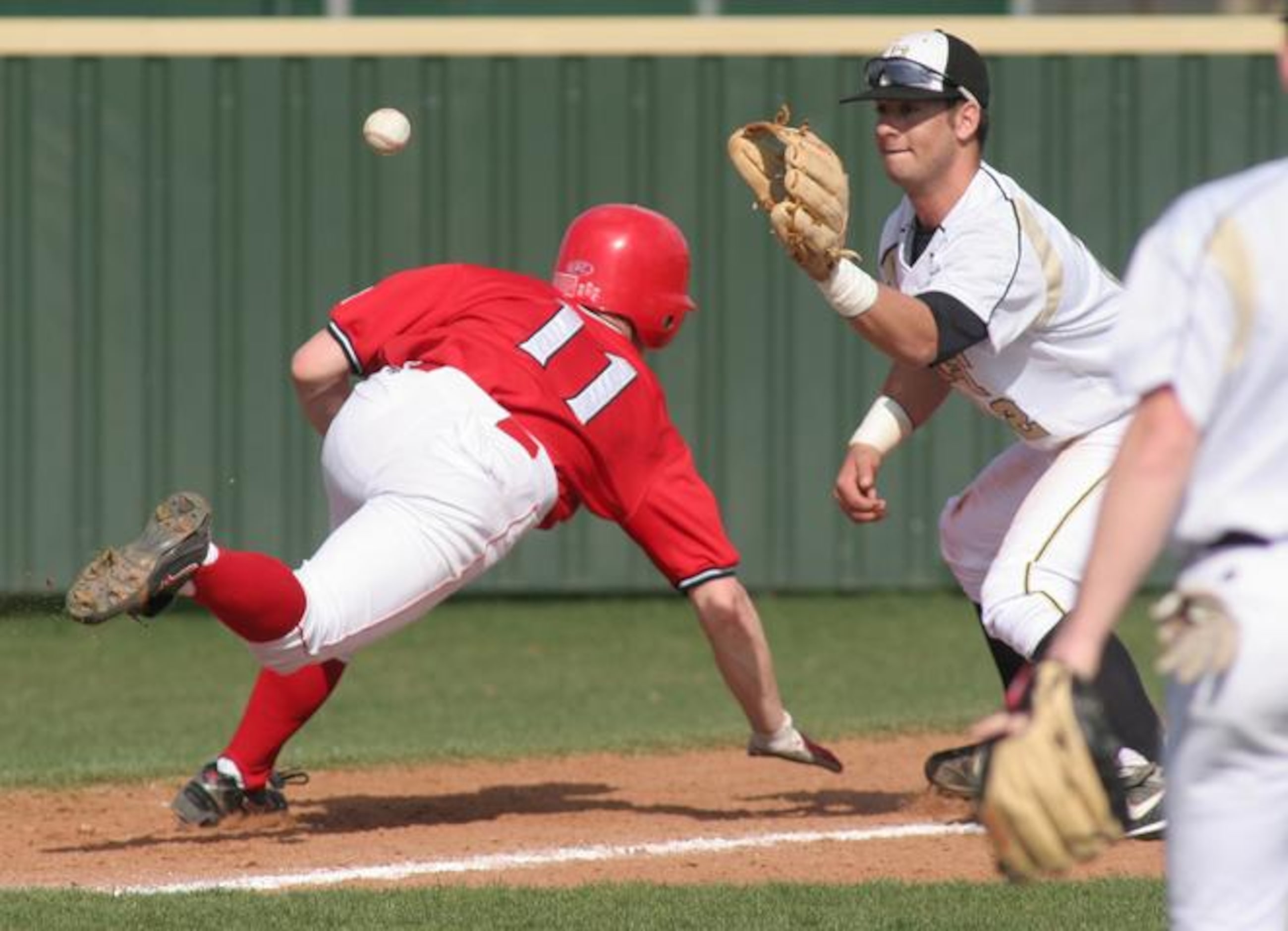 Justin Northwest's Jeremy Dwiggins (11) makes it back to third safely as Plano East's Justin...