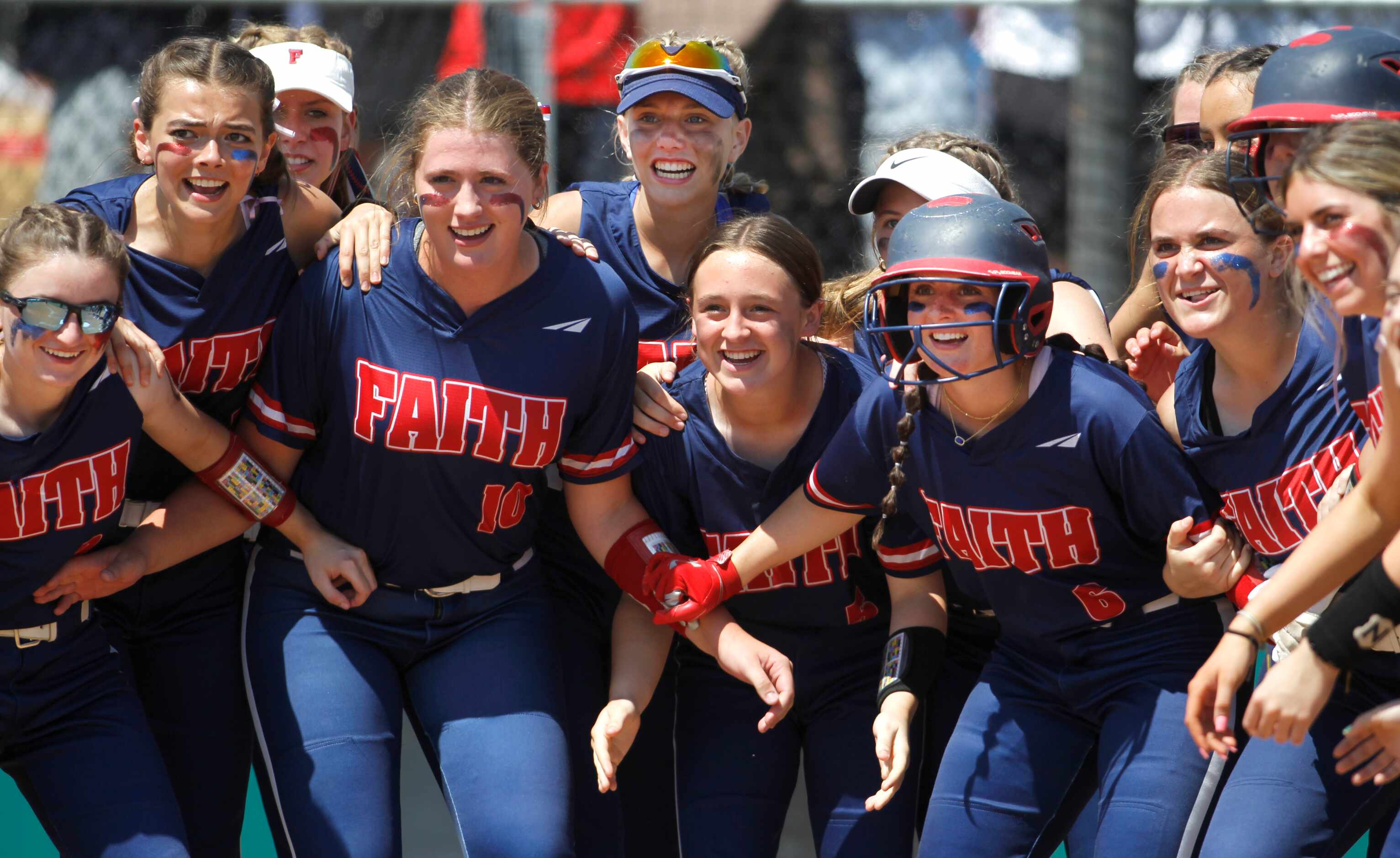 Grapevine Faith Christian players form a welcoming party at the plate to celebrate...